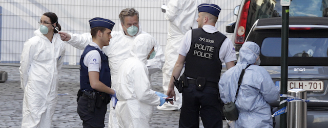 Forensic experts examine the site of a shooting at the Jewish museum in Brussels, Saturday, May 24, 2014. Belgian officials say that at least three people have been killed in gunfire at the Jewish Museum in Brussels. Belgian Foreign Minister Didier Reynders, in a post on Twitter, said he was "shocked by the murders committed at the Jewish Museum" on Saturday afternoon. He said he had seen the bodies of the victims. At least three persons were killed in the incident, and a Brussels fire department spokesman said one person was wounded. (AP Photo/Yves Logghe)