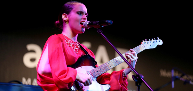 MILAN, ITALY - SEPTEMBER 22: Anna Calvi performs on stage at the amfAR Milano 2012 during Milan Fashion Week at La Permanente on September 22, 2012 in Milan, Italy. (Photo by Andreas Rentz/Getty Images)