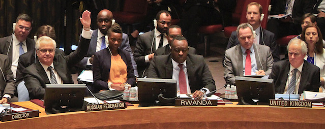 Russia's U.N. Ambassador Vitaly Churkin, second from left, raise his hand against a U.N. Security Council vote on referring the Syrian crisis to the International Criminal Court for investigation of possible war crimes, Thursday, May 22, 2014. The resolution was vetoed with Russia and China, two of the council's permanent members, voting against. (AP Photo/Bebeto Matthews)