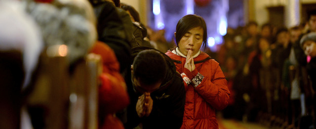 Chinese worshippers pray during the Christmas Eve mass at a Catholic church in Beijing early on December 25, 2012. While China does not officially celebrate Christmas, its popularity continues to grow with non-Christians keen to see and feel the experience of Christmas. AFP PHOTO / WANG ZHAO (Photo credit should read WANG ZHAO/AFP/Getty Images)