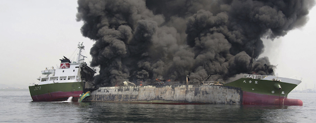 In this photo released by Japan's 5th Regional Coast Guard, clouds of black smoke billow from Shoko Maru, a 998-ton Japanese oil tanker, after it exploded off the southwest coast near Himeji port, western Japan, Thursday, May 29, 2014. One of the eight people aboard is missing and the other seven were injured, according to the coast guard. (AP Photo/Japan's 5th Regional Coast Guard) MANDATORY CREDIT