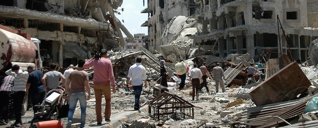 Syrians return to the Juret al-Shayah district of the central city of Homs on May 10, 2014, after the last Syrian rebels left the city's neighbourhood under an evacuation deal that hands the government a symbolic victory. Rebel forces in the Old City were under government siege for nearly two years before the deal to evacuate, and regime troops shelled the area almost daily throughout. AFP PHOTO / STR (Photo credit should read -/AFP/Getty Images)