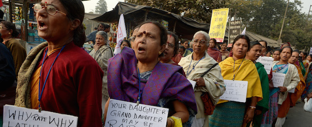 Leftist women activists carry posters as they shout slogans during a protest march against the gangrape and murder of a teenager, in Kolkata on January 3, 2014. An Indian teenager near the eastern city of Kolkata has been gangraped twice and then burned alive, police said, sparking protests after she died of her injuries. The 16-year-old was assaulted first on October 26, 2013 and then again the day after by a group of more than six men near her family's home in Madhyagram town, about 25 kilometres (15 miles) north of Kolkata. After being set on fire on December 23, she died in a state-run hospital on December 31. AFP PHOTO/Dibyangshu SARKAR (Photo credit should read DIBYANGSHU SARKAR/AFP/Getty Images)