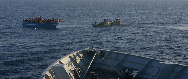 In this photo released by the Italian Navy Wednesday, April 9, 2014, Italian Navy's dinghies approach a boat carrying migrants along the Mediterranean sea, off the Sicilian island of Lampedusa. Italian authorities say some 4,000 migrants have been rescued at sea in the past 48 hours as the exodus from Libya continues unabated. Interior Minister Angelino Alfano said Wednesday that around 15,000 migrants have been rescued since the start of the year and that there were between 300,000 and 600,000 people in Libya ready to board smuggling boats. (AP Photo/Italian Navy, ho )