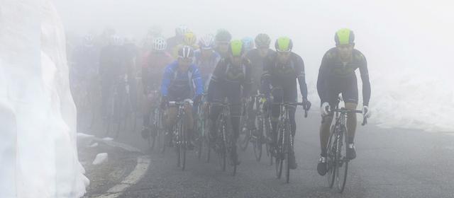 Movistar team cyclists lead the pack as they climb among fog and snow during the 16th stage of the Giro d' Italia cycling race from Ponte di Legno to Val Martello, Italy, Tuesday, May 27, 2014. Movistar's Nairo Quintana, of Colombia, won the stage and became the new leader of the race. (AP Photo/Fabio Ferrari)