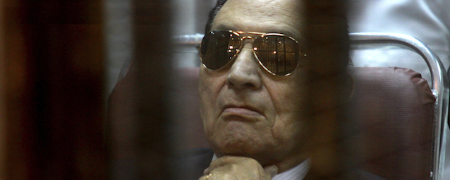 Ousted Egyptian President Hosni Mubarak attends a hearing in his retrial over charges of failing to stop killings of protesters during the 2011 uprising that led to his downfall, in the Police Academy-turned-court in the outskirts of Cairo, Egypt. Saturday, April 26, 2014. (AP Photo/Tarek el Gabbas)