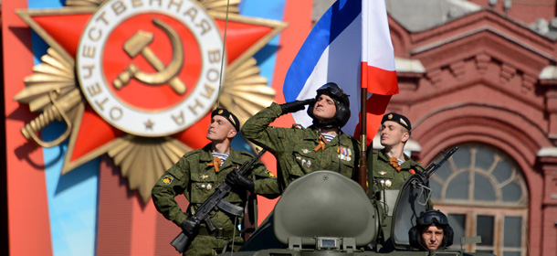 Russian soldiers ride atop their armoured personnel carrier at the Red Square in Moscow, on May 9, 2014, during a Victory Day parade. Thousands of Russian troops marched today in Red Square to mark 69 years since victory in World War II in a show of military might amid tensions in Ukraine following Moscow's annexation of Crimea. AFP PHOTO / KIRILL KUDRYAVTSEV (Photo credit should read KIRILL KUDRYAVTSEV/AFP/Getty Images)