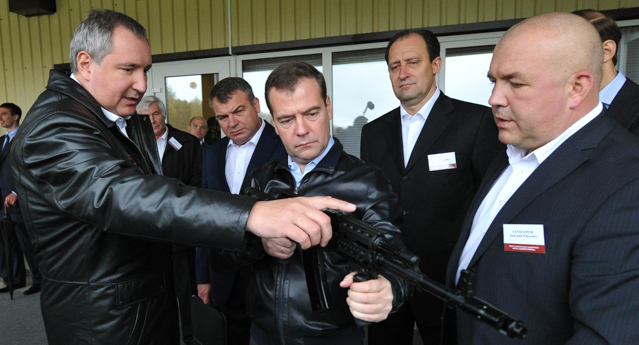 Russian Prime Minister Dmitry Medvedev, centre, listens to deputy premier Dmitry Rogozin, as he visits a factory, producing weapons components in Klimovsk outside Moscow on Wednesday, Oct. 3, 2012. Russian Defense Minister Anatoly Serdyukov stands third left. (AP Photo/RIA Novosti, Alexander Astafyev, Government Press Service)