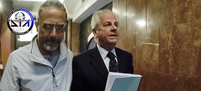 This image made from a video made available by the Italian anti-mafia DIA unit shows Claudio Scajola, right, a former minister in several of Silvio Berlusconi's center-right governments, as he is taken to the DIA headquarters after he was arrested Thursday, May 8, 2014, in a luxury Rome hotel, for allegedly helping a prominent businessman convicted of Mafia association flee abroad. Claudio Scajola was accused of helping political ally Amedeo Matacena flee to Dubai last summer to avoid a five-year jail sentence and of then trying to arrange asylum for him and relatives in Lebanon using government contacts. (AP Photo/DIA, ho)