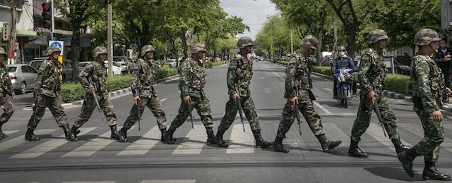 BANGKOK, THAILAND - MAY 23: Thai soldiers patrol near government buildings on May 23, 2014 in Bangkok, Thailand. The Army chief announced in an address to the nation that the armed forces were seizing power in a non-violent coup. Thailand has seen months of political unrest and violence which has claimed at least 28 lives. (Photo by Paula Bronstein/Getty Images)