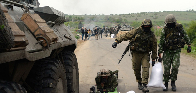 Ukrainian troops build a sandbag barricade at a checkpoint they seized in the early morning in the village of Andreevka, 7 kms from the centre of the southern Ukrainian city of Slavyansk, on May 2, 2014. Ukraine's military lost two helicopters and two servicemen on May 2 in a deadly offensive launched just before dawn against pro-Russian rebels holding the flashpoint town of Slavyansk, insurgents and authorities said. AFP PHOTO / VASILY MAXIMOV (Photo credit should read VASILY MAXIMOV/AFP/Getty Images)