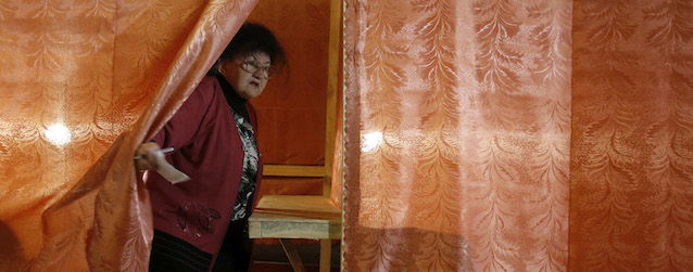 An elderly woman leaves a polling booth at a polling station in the center of Slovyansk, eastern Ukraine, Sunday, May 11, 2014. Residents of two restive regions in eastern Ukraine engulfed by a pro-Russian insurgency are casting ballots in contentious and hastily organized independence referenda. Sunday's ballots seek approval for declaring so-called sovereign people's republics in the Donetsk and Luhansk regions, where rebels have seized government buildings and clashed with police and Ukrainian troops. (AP Photo/Darko Vojinovic)