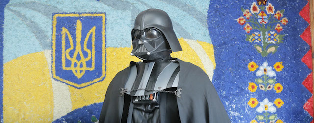 Darth Vader the Ukrainian Internet Party mayoral candidate for Kiev and Odessa speaks to press in front of a painting of the Ukrainian flag at a polling station during the presidential and mayoral elections in Kiev, Ukraine, Sunday, May, 25, 2014. (AP Photo/Efrem Lukatsky)