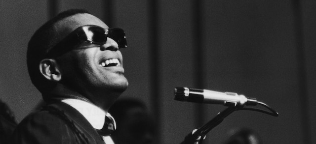 American soul singer and pianist Ray Charles sings on stage during his first British concert appearance at Finsbury Park, London, England, May 13, 1963. (Photo by Express Newspapers/Getty Images)