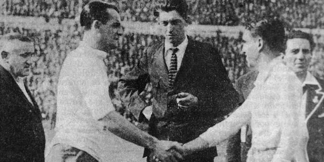 30th July 1930: Uruguayan captain Jose Nazassi (left) shakes hands with his Argentinian counterpart 'Nolo' Fereyra before the final of the first world Cup competition in Montevideo, which Uruguay won . With them is referee John Langenus and linesmen Saucedo and Henry Christophe. Uruguay won 4-2. (Photo by Keystone/Getty Images)