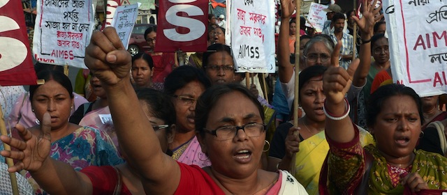 Indian activists from the Social Unity Center of India (SUCI) shout slogans against the state government in protest against the gang-rape and murder of two girls in the district of Badaun in the northern state of Uttar Pradesh and recent rapes in the eastern state of West Bengal, in Kolkata on June 7, 2014. The protests came amid a growing uproar over the killings in Uttar Pradesh, with the United Nations saying violence against women should be regarded as a matter of basic human rights. The two cousins, aged 14 and 12, were found hanging from a mango tree in their impoverished village, with subsequent tests showing they had been the victim of multiple sexual assaults. AFP PHOTO/ Dibyangshu Sarkar (Photo credit should read DIBYANGSHU SARKAR/AFP/Getty Images)