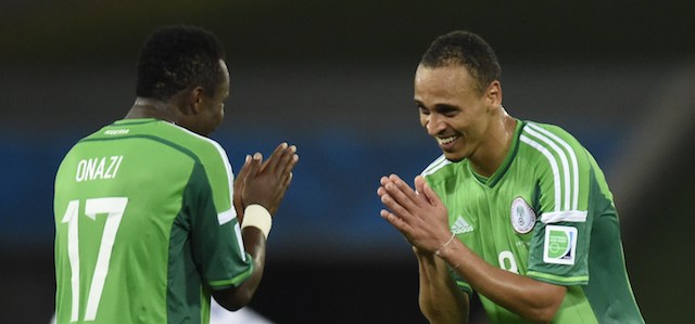 Nigeria's midfielder Ogenyi Onazi (L) and Nigeria's forward Peter Odemwingie celebrate after winning the Group F football match between Nigeria and Bosnia-Hercegovina at the Pantanal Arena in Cuiaba during the 2014 FIFA World Cup on June 21, 2014. AFP PHOTO / JUAN BARRETO