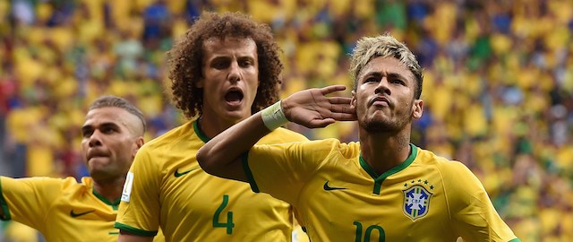 Brazil's forward Neymar celebrates after scoring a goal during the Group A football match between Cameroon and Brazil at the Mane Garrincha National Stadium in Brasilia during the 2014 FIFA World Cup on June 23, 2014. AFP PHOTO / PEDRO UGARTE