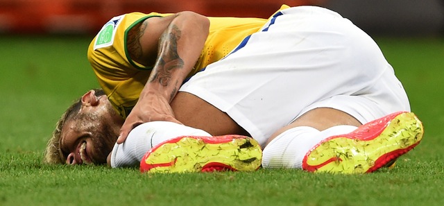 Brazil's forward Neymar lies on the pitch after being injured during a Group A football match between Cameroon and Brazil at the Mane Garrincha National Stadium in Brasilia during the 2014 FIFA World Cup on June 23, 2014. AFP PHOTO / FRANCOIS XAVIER MARIT