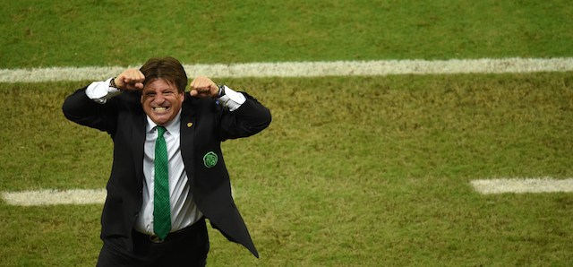 Mexico's coach Miguel Herrera celebrates after his team won a Group A football match between Croatia and Mexico at the Pernambuco Arena in Recife during the 2014 FIFA World Cup on June 23, 2014. Mexico won 3-1. AFP PHOTO / JAVIER SORIANO