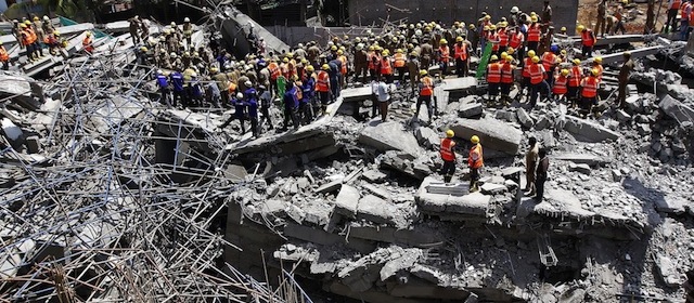 Indian rescue workers look for survivors in the rubble of a collapsed multi-storeyed building in Porur town, situated on the outskirts of Chennai on June 29, 2014. At least nine people were killed and dozens feared trapped after an 11-storey residential block crumbled in southern India, officials said, the latest deadly building collapse in the country. AFP PHOTO (Photo credit should read STR/AFP/Getty Images)