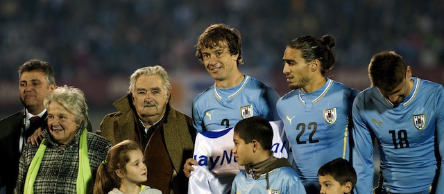 Uruguay's President Jose Mujica (3rd L) and his wife Lucia Topolansky (2nd L) stand next to Uruguay's footballers (L to R) Diego Lugano, Martin Caceres and Nestor Ramirez before the start of the friendly football match agaisnt Slovenia at the Centenario Stadium in Montevideo on June 4, 2014, in preparation for the upcoming FIFA World Cup 2014 in Brazil. AFP PHOTO/Miguel Rojo (Photo credit should read MIGUEL ROJO/AFP/Getty Images)