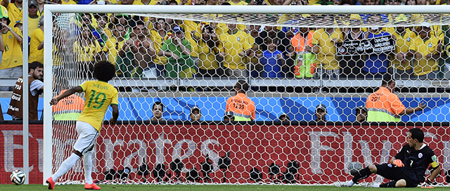 Brazil's Willian misses a penalty in a shoot out at the end of the World Cup round of 16 soccer match between Brazil and Chile at the Mineirao Stadium in Belo Horizonte, Brazil, Saturday, June 28, 2014. Brazil won the match 3-2 on penalties after the match ended 1-1. (AP Photo/Martin Meissner)