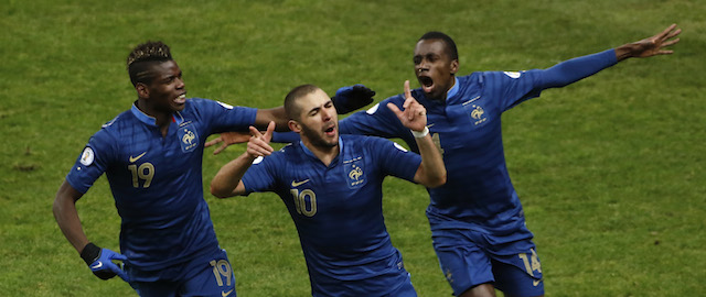 France's Karim Benzema, center, celebrates with teammate Paul Pogba, left, and Blaise Matuidi, right, after scoring during their World Cup qualifying playoff second-leg soccer match between France and Ukraine at Stade de France stadium, in Saint Denis, outside Paris, Tuesday, Nov. 19, 2013. (AP Photo/Thibault Camus)