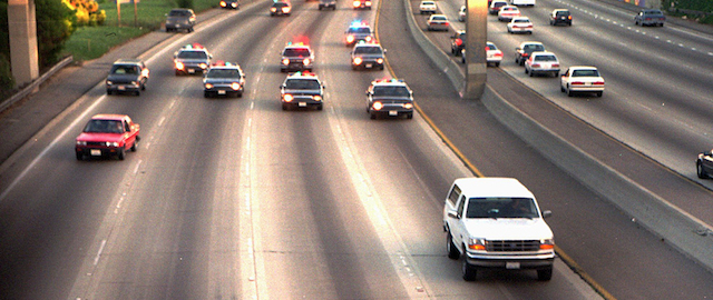 FILE - In this June 17, 1994 file photo, a white Ford Bronco, driven by Al Cowlings carrying O.J. Simpson, is trailed by Los Angeles police cars as it travels on a Southern California freeway in Los Angeles. Cowlings and Simpson led authorities on a chase after Simpson was charged with two counts of murder in the deaths of his ex-wife, Nicole Brown Simpson, and her friend, Ron Goldman. (AP Photo/Joseph Villarin, File)