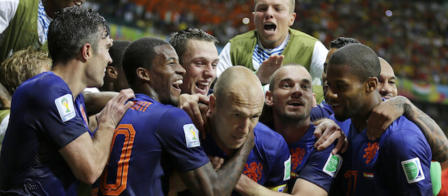 Netherlands' Arjen Robben, center, celebrates with his teammates after scoring his side's fifth goal during the second half of the group B World Cup soccer match between Spain and the Netherlands at the Arena Ponte Nova in Salvador, Brazil, Friday, June 13, 2014. (AP Photo/Natacha Pisarenko)
