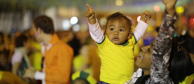 Brazilians soccer fans of all ages, cheer after Brazil scored against Cameroon while watching the match on a giant television screen in Bixiga neighborhood in Sao Paulo, Brazil, Monday, June 23, 2014. Brazil's Neymar scored twice in the first half to lead Brazil to a 4-1 win over Cameroon on Monday, helping the hosts secure a spot in the second round of the soccer World Cup. (AP Photo/Nelson Antoine)