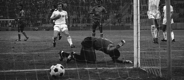 Yugoslavia’s Branko Oblek jumps for joy, as Zaire’s substitute goalkeeper Dimbi Tubilandu beats the ground in frustration, after Oblek scored Yugoslavia’s seventh goal in the World Cup finals soccer match at Gelsenkirchen, West Germany on June 18, 1974. Other players are Yugoslavia’s Ilija Petkovie, left, and Zaire’s Ilunga Mwepu. Yugoslavia went on to win the match 9-0. (AP Photo)