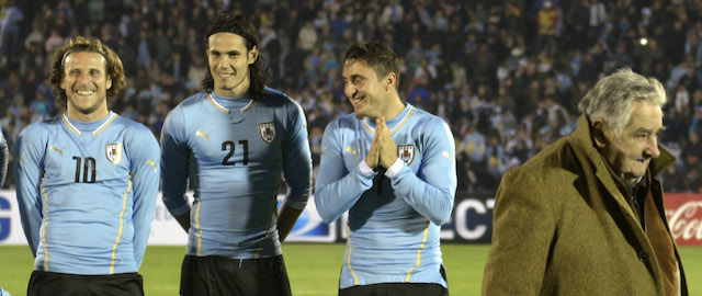 From left to right, Uruguay's players Diego Godin, Diego Forlan, Edinson Cavani, Christian Rodriguez watch Uruguay's President Jose Mujica leaving the field, before a friendly soccer match in Montevideo, Uruguay, Wednesday, June 4, 2014. (AP Photo/Matilde Campodonico)