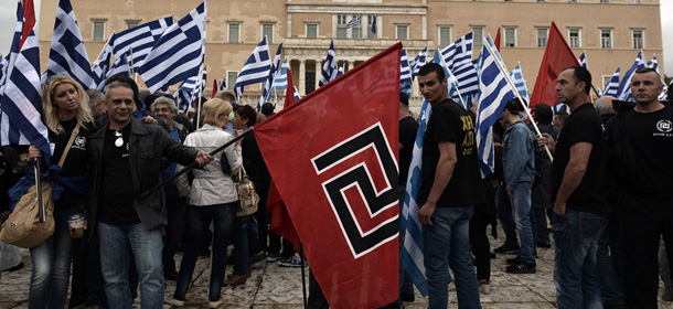 Supporters of the Golden Dawn ultra nationalist party gather in front of the Greek parliament in Athens on June 4, 2014. Around 400 Golden Dawn supporters gathered in Athens early on Wednesday outside parliament, which must make a decision on lifting immunity for the leader of the extreme right party, according to a police source.Nikolaos Michaloliakos has been in provisional detention since September for belonging "to a criminal organisation." AFP PHOTO / LOUISA GOULIAMAKI (Photo credit should read LOUISA GOULIAMAKI/AFP/Getty Images)