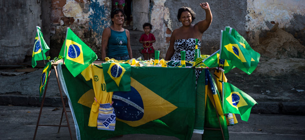 Street vendors sell Brazilian paraphernalia for the FIFA World Cup Brazil 2014 in Rio de Janeiro, Brazil, on June 11, 2014, on the eve of the opening of the event. AFP PHOTO / YASUYOSHI CHIBA (Photo credit should read YASUYOSHI CHIBA/AFP/Getty Images)