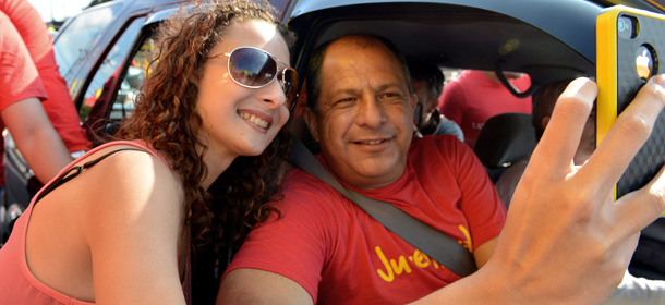 Costa Rican presidential candidate for the Partido Accion Ciudadana (Citizenship Action Party) Luis Guillermo Solis (R) takes a picture with a supporter along the streets of Coronado, San Jose on March 30, 2014. It is still unclear who Solis will face in the runoff presidential election next April 6, following the decision by Partido Liberacion Nacional (National Libertation Party) candidate Johnny Araya to stop campaigning and step down. AFP PHOTO / Ezequiel BECERRA (Photo credit should read EZEQUIEL BECERRA/AFP/Getty Images)