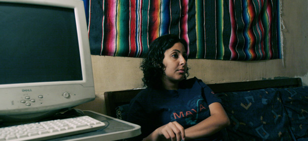** FILE ** Manal Hassan, 23, the wife of Alaa Abdel-Fattah with her cat in her lab is seen at her apartment in Cairo, Egypt Wednesday May 17, 2006. Even from his cell in an Egyptian prison, Alaa Abdel-Fattah is blogging _ scribbling messages on slips of paper that make their way to the Internet and spread like wildfire. (AP Photo/Nasser Nasser) ** ZU KORR APD1943 **
