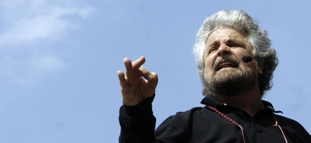 FILE - In this April 25, 2008 file photo Italian comedian-turned-moralizer Beppe Grillo, speaks to supporters at a rally in Piazza San Carlo square in Turin, northern Italy. An anti-euro candidate has triumphed in mayoral runoffs in Italy's affluent north. Results Monday of second-round balloting also saw winning big a candidate whose party is one of the few forces in Parliament opposing Premier Mario Monti's austerity measures. Federico Pizzarotti, the candidate of comic Beppe Grillo's anti-euro populist Five-Star Movement, captured the mayor's post in Parma. (AP Photo/Massimo Pinca, FILE)