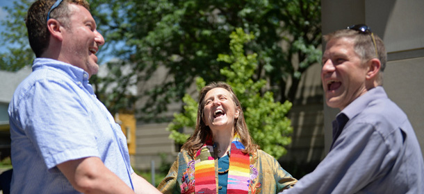 Rev. Mary Ann Macklin, center, officiates the wedding ceremony for Jeff Jewel, left, and Jeff Polling, who have been together for 18 years, on the steps of the Monroe County Justice Building in Bloomington, Ind. on Wednesday, June 25, 2014. A federal judge struck down Indiana's ban on same-sex marriage Wednesday in a ruling that immediately allowed gay couples to wed. (AP Photo, Bloomington Herald-Times, Chris Howell)