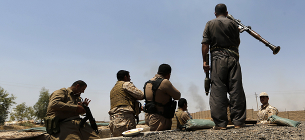 Iraqi Kurdish forces take position as they fight jihadist militants from the Islamic State of Iraq and the Levant (ISIL) on June 29, 2014 in the Iraqi village of Bashir (Basheer), 20 kilometers south of the city of Kirkuk. Iraqi forces pressed a counter-attack on Saddam Hussein's hometown of Tikrit as Russia delivered Sukhoi warplanes to aid Baghdad in what diplomats warn is an existential battle against Sunni militants. AFP PHOTO /KARIM SAHIB (Photo credit should read KARIM SAHIB/AFP/Getty Images)