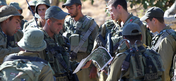 Israeli soldiers check a map at the start of a search operation in the West Bank city of Hebron on June 26, 2014, to try to locate the three teenagers the army believes were abducted by Islamist movement Hamas on June 12. Israeli Israeli Prime Minister Benjamin Netanyahu praised Palestinian president Mahmud Abbas for condemning the alleged kidnapping of three teenagers by Hamas, but criticised his unity pact with the Islamist movement. Netanyahu spoke as Israel began to wind down a huge crackdown on Hamas, having arrested hundreds in an operation to find the youngsters who went missing in the southern West Bank nearly two weeks ago. AFP PHOTO/HAZEM BADER (Photo credit should read HAZEM BADER/AFP/Getty Images)