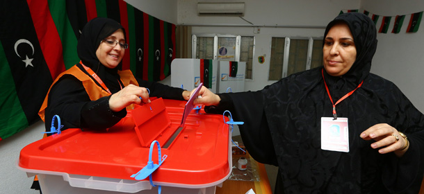 A Libyan woman casts her vote in legislative elections for choosing 200 members of the General National Congress, or parliament, at a polling station in the capital in Tripoli on June 25, 2014. Polling was under way across Libya in a general election seen as crucial for the future of a country hit by months of political chaos and growing unrest. AFP PHOTO/MAHMUD TURKIA (Photo credit should read MAHMUD TURKIA/AFP/Getty Images)