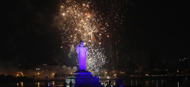 In this Sunday, June 1, 2014, photo, close to midnight, fireworks display behind the Buddha statue at Hussain sagar lake to mark and celebrate the formation of India's 29th state, Telangana, in Hyderabad, India. Celebrations greeted the creation Monday of India's newest state of Telangana, marking the formal division of the southern state of Andhra Pradesh. (AP Photo/Mahesh Kumar A.)