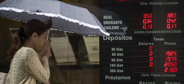 The board of an exchange house in downtown Buenos Aires reads the rate of 7.80 argentine pesos to one dollar, sale rate and 8.10 to buy, on January 24, 2014. Argentina on Friday lifted restrictions in place since 2011 that limited the purchase of foreign currency, a day after the peso suffered its worst single-day dive since the 2002 financial crisis. The government has decided "to authorize the purchase of dollars for holding or savings," said Jorge Capitanich, President Cristina Kirchner's cabinet chief. The restrictions had always been temporary and had served their purpose, said Capitanich. He added that, at a rate of 8.01 pesos to the dollar, the peso "has reached a level acceptable to the objectives of economic policy convergence." The move came with the peso in free fall, plunging more than 11 percent against the dollar on Thursday. (Photo credit should read LEO LA VALLE/AFP/Getty Images)