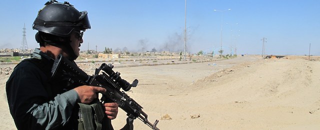 A member of the Iraqi government forces looks on during a military operation in the Iraqi city of Ramadi, west of the capital Baghdad on May 20, 2014. Iraq is experiencing a protracted surge in unrest with violence at its worst since 2008. More than 3,500 people have been killed already this year, according to an AFP tally. AFP PHOTO / AZHAR SHALLAL (Photo credit should read AZHAR SHALLAL/AFP/Getty Images)