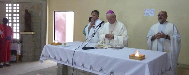 This photo released by Vicenza Diocese, Saturday April 5, 2014 shows Vicenza Bishop Beniamino Pizziol, center, flanked by father Gianantonio Alllegri, right, and Giampaolo Marta, left, during a mass in Tchakidjebe church, near Maroua, Cameroon, during a visit on Jan. 2014. Officials say two Italian priests and a Canadian nun working as missionaries in northern Cameroon have been abducted. Italy's foreign ministry said the abduction occurred during the night between Friday and Saturday about 30 kilometers (20 miles) from the border with Nigeria. It identified the priests as Giampaolo Marta and Gianantonio Allegri, but declined to give other details, including the Canadian's identity, to avoid compromising efforts for the missionaries' release.( AP Photo/Vicenza Diocese)