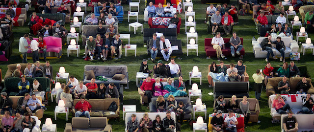 German soccer fans watch the opening game of the World Cup while sitting on sofas in the 1.FC Union stadium in Berlin, Thursday, June 12, 2014. (AP Photo/Axel Schmidt)
