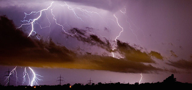 Lightnings photographed at Algermissen, near Hildesheim, northern Germany early Tuesday June 10, 2014. Authorities say at least six people were killed in western Germany as heavy rains, hail and high winds battered the region. In the North Rhine-Westphalia capital of Duesseldorf, police said two men and a woman who had sought refuge in a garden house were killed late Monday when a large tree fell on the building, the dpa news agency reported Tuesday. Firefighters were able to rescue six others, and rushed them to hospitals for treatment. Many flights from Duesseldorf airport were delayed and some train routes were still closed Tuesday. ( AP Photo/dpa,Julian Stratenschulte)