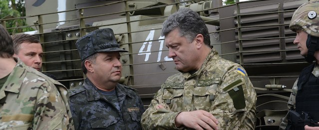 Ukrainian President Petro Poroshenko, wearing military fatigues, speaks with Ukrainian army's Anti-Terrorist Operation (ATO) officers at their headquarters near the eastern Ukrainian city of Izyum, during his visit of the Donetsk region, on June 20, 2014. Poroshenko announced on June 20 that a week-long unilateral ceasefire would begin in the separatist east later in the day to give the pro-Russian rebels a chance to disarm. AFP PHOTO/ SERGEY BOBOK (Photo credit should read SERGEY BOBOK/AFP/Getty Images)