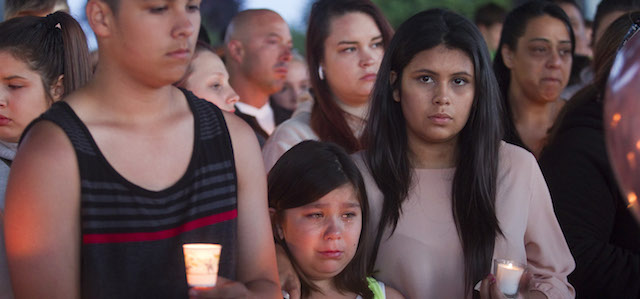 TROUTDALE, OR - JUNE 10: Friends, family and others hold candles for Emilio Hoffman, the victim of today's school shooting at a vigil in Troutdale, Oregon June 10, 2014. A gunman walked into Reynolds High School with a rifle and shot 14 year old Hoffman to death on Tuesday before he was later found dead, in what is the the third outbreak of gun violence to shake a U.S. school in less than three weeks. (Photo by Natalie Behring/Getty Images)